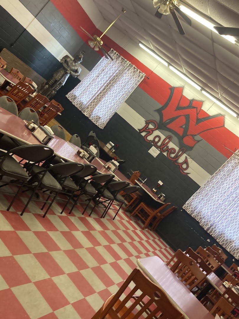 Casual family restaurant dining room with simple tables.