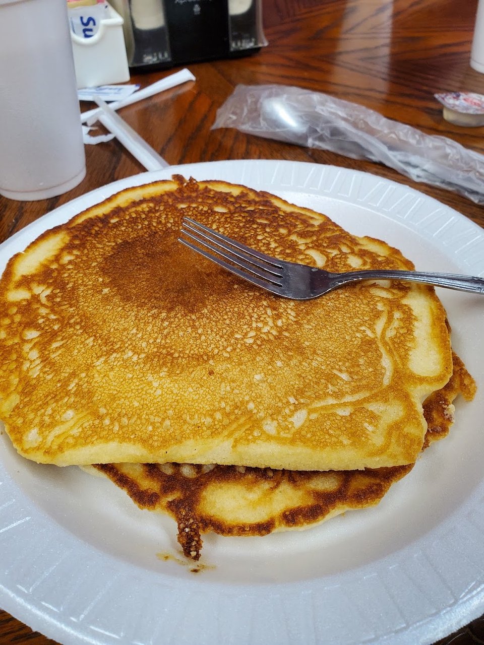 Printed menu beside breakfast dishes and hot plates.